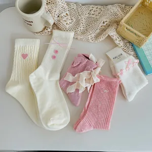 Detailed collection of cute pink and white socks with bow ribbons and lace details