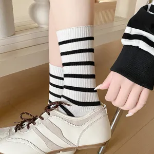 Close-up of white and black striped mid-calf cotton socks in Korean style
