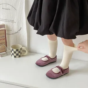 Cozy autumn winter fine vertical stripe cotton mid tube socks paired with stylish velvet shoes.