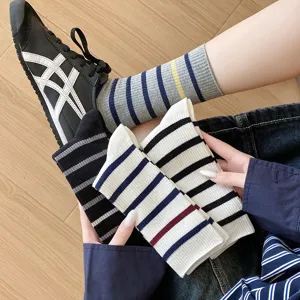 Close-up of colorful striped cotton crew socks for women in minimalist casual style