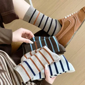 Detailed macro view of assorted striped cotton mid-calf socks showing various color patterns