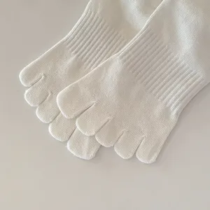 Detail view of white five-finger socks with seamless knit and soft ribbed texture