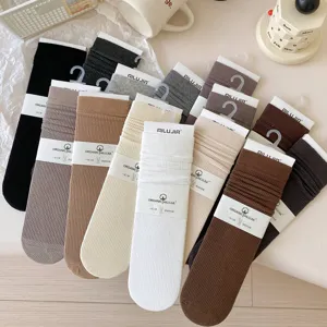Detailed view of ribbed mid-calf socks in assorted neutral colors, soft texture and cozy.