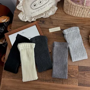 Detailed view showing multiple colors of ribbed knitted leg warmers for autumn and winter