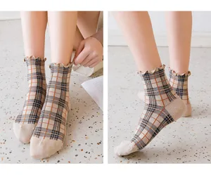 Close-up detail showing the cute plaid pattern and sweet ruffle lace trim on these soft socks.