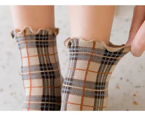 Detailed view of women plaid cotton socks with cute ruffled lace cuffs, korean style.
