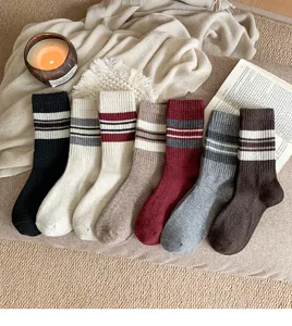 Cozy wool-blend mid-calf socks featuring classic striped patterns, detail view of multi-color stack.