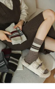 Cozy autumn winter women's mid-tube socks with classic striped preppy style design.