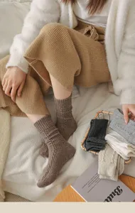 Detail shot of Japanese vintage cable knit wool crew socks, cozy winter warmth.