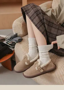 Cozy wool cable-knit slouch socks styled with warm fleece-lined slip-on shoes for winter comfort.