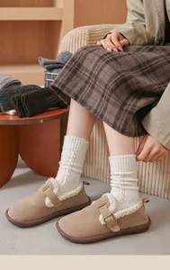Detailed shot of cozy cable-knit wool socks paired with fuzzy winter shoes, lifestyle view.