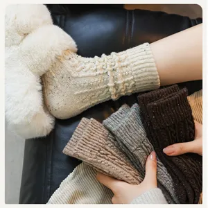 Close-up of thick cable-knit wool socks with colorful speckles, soft winter texture details.