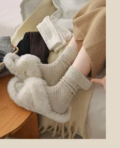 Cozy cable-knit wool socks detail shot showing warm winter texture and soft slouchy design fit.