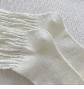 White ribbed mid-calf socks for women, comfortable cotton blend stacking daily wear detail.