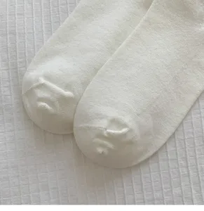 White women cotton socks close-up, seamless toe design, soft knit texture, simple style detail.