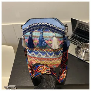 Nahaufnahme einer Hand, die eine böhmische Beuteltasche mit lebhaften Mustern hält