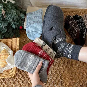Cozy winter wool socks featuring classic Fair Isle snowflake patterns. Soft, warm knit detail.