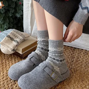 Cozy women's winter wool socks with Nordic snowflake pattern, mid-calf length, warm and stylish knit.