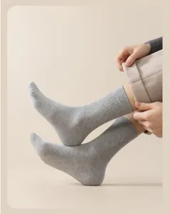 Gros plan sur des chaussettes en laine côtelée grise pour homme, texture tricotée confortable.