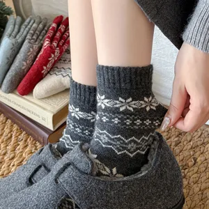 Cozy winter wool socks for women featuring classic Fair Isle snowflake patterns and warm fit.