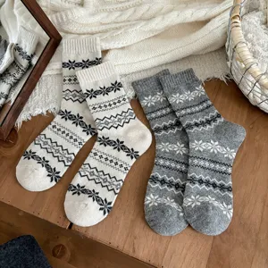 Close-up detail shot of winter warm Fair Isle knit wool socks with classic snowflake pattern.