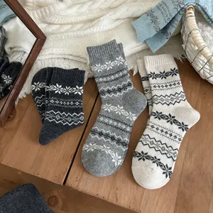 Women wool blend mid-tube winter socks with classic Nordic Fair Isle snowflake pattern design.
