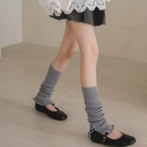 Grey knitted leg warmers for women, cozy winter college style boot cuffs with button details.