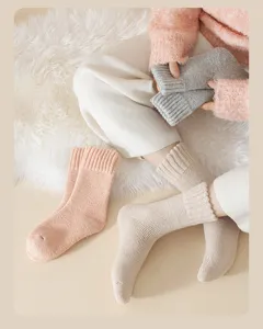Close-up detail of cozy warm thick wool winter socks in soft solid colors for women.