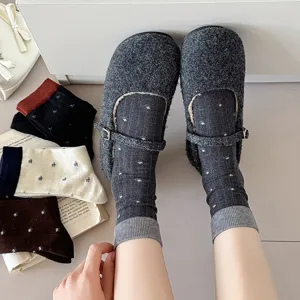 Cozy grey wool Mary Jane shoes paired with cute floral crew socks, detailed look.