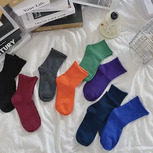 Detailed view of women solid color roll cuff socks in multiple vibrant colors nicely arranged.