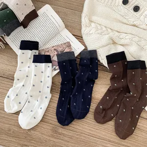 Detailed shot of Korean style wool crew socks featuring cute floral patterns and color block cuffs.