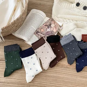 Cozy wool blend women socks with contrast cuffs and cute floral pattern detail shot.
