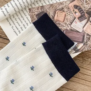 Cozy cotton floral mid-calf socks with contrast color cuffs for women stylish daily wear.