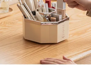 Detailed view of the rotating cream-colored makeup organizer on a wooden vanity.