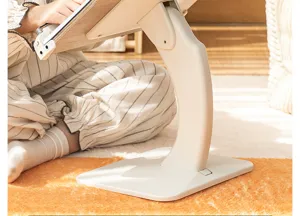 Close-up detail of the sturdy base and adjustable arm of a cream-colored reading stand