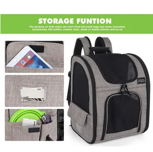 Detail view of storage pockets on pet carrier backpack showing tablet and accessories.