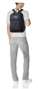 Detailed back view of a lightweight black backpack worn by a male model in a white studio