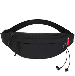 Detail of black travel waist bag showing functional earphone hole and zipper pockets