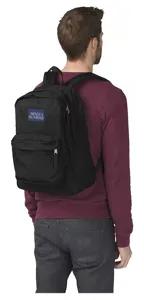 Back view showing the fit and size of a lightweight black nylon backpack on a model.