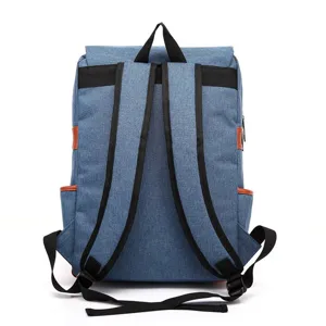 Back view of a vintage blue canvas laptop backpack with comfortable black shoulder straps