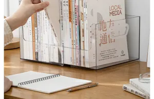 Detailed close-up view of a transparent retractable book organizer on a wooden desk