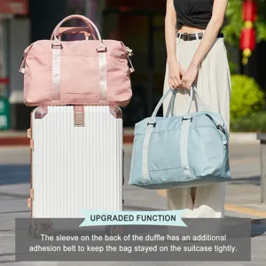 Detail showing the travel duffle bag with a suitcase sleeve for secure trolley attachment