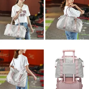 Stylish gray travel duffel bag with pink straps shown as a gym and luggage companion.
