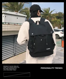 Rear view of a stylish black water-repellent large-capacity backpack in an urban setting