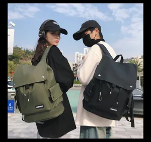 Two models wearing large waterproof flap top backpacks in olive and black colors
