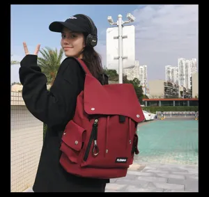 Asian woman wearing a stylish red waterproof backpack in an outdoor urban setting