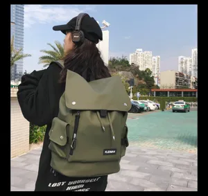 Outdoor view of an olive green water-repellent backpack with large capacity