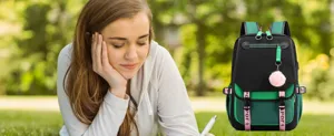 Detail of modern green and black student backpack with USB charging port and pink charm