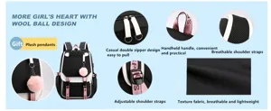 Detail view of black school backpack featuring plush pendants and USB charging port