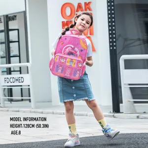 Girl posing with a cute pink cartoon school backpack for primary school students